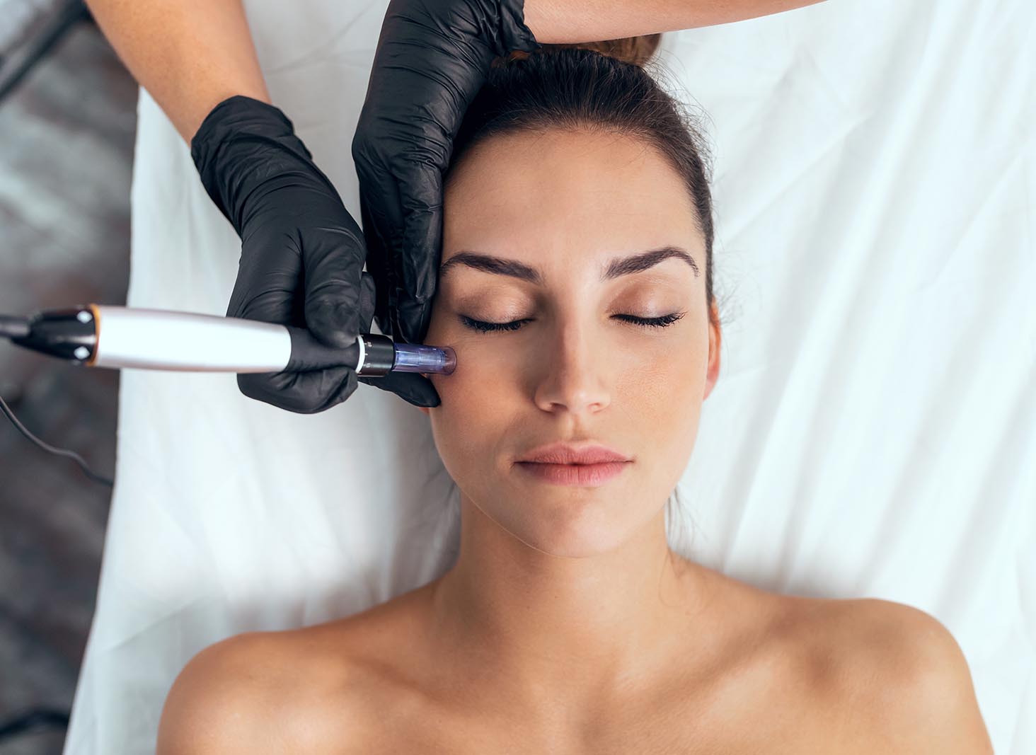 Shot of cosmetologist making mesotherapy injection with dermapen on face for rejuvenation on the spa center.